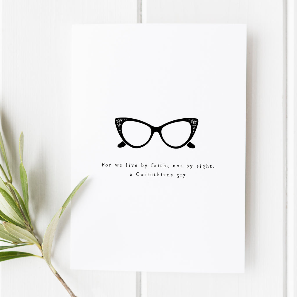 For We Live by Faith print featuring cat-eye glasses design, 2 Corinthians 5:7 scripture art, stylish Christian decor, perfect faith-inspired Christmas gift