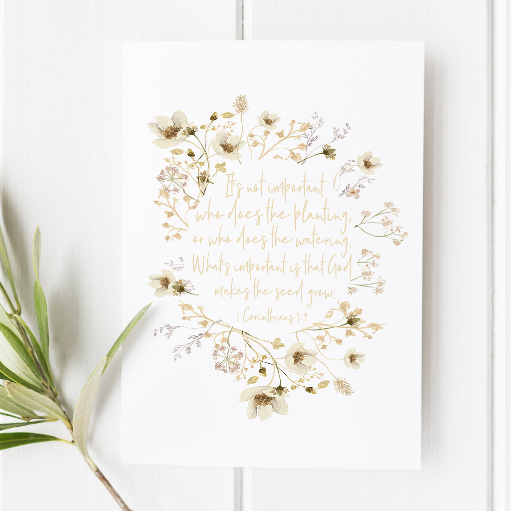 1 Corinthians 3:7 print with delicate floral wreath in neutral tones; inspiring Bible verse wall art for Christian decor, faith encouragement, and thoughtful gifts.