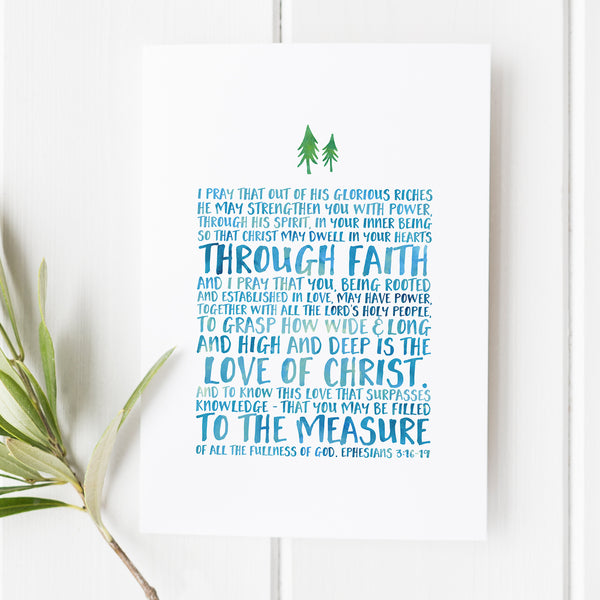 A bible verse art print from Snow and Company featuring Ephesians 3:16-19. The verse is written in a whimsical sans serif font in light blue under two watercolor pine trees. The print is aimed towards boys but is the perfect christian gift for anyone